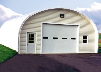 S Series Metal Shed painted with one large garage door and one regular door