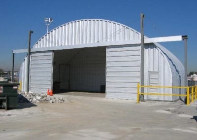 An example of one of our Gray Industrial Steel Garage with large sliding door