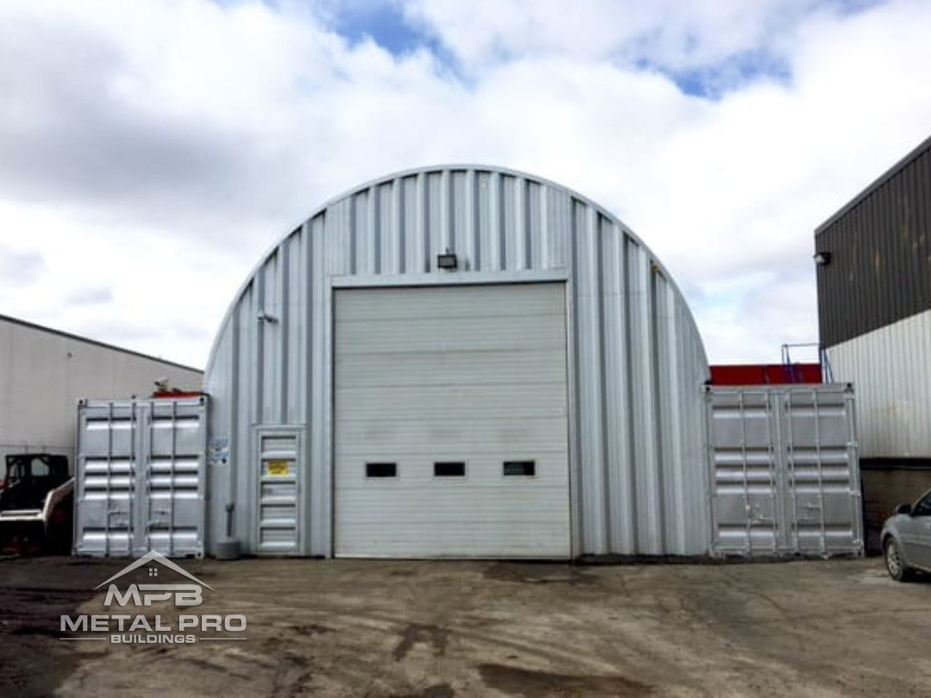 exterior of a quonset hut shipping container building