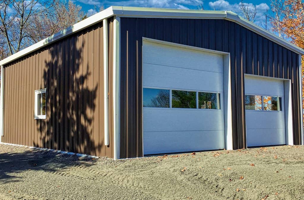 Prefab garage steel building with one large door and one regular door.