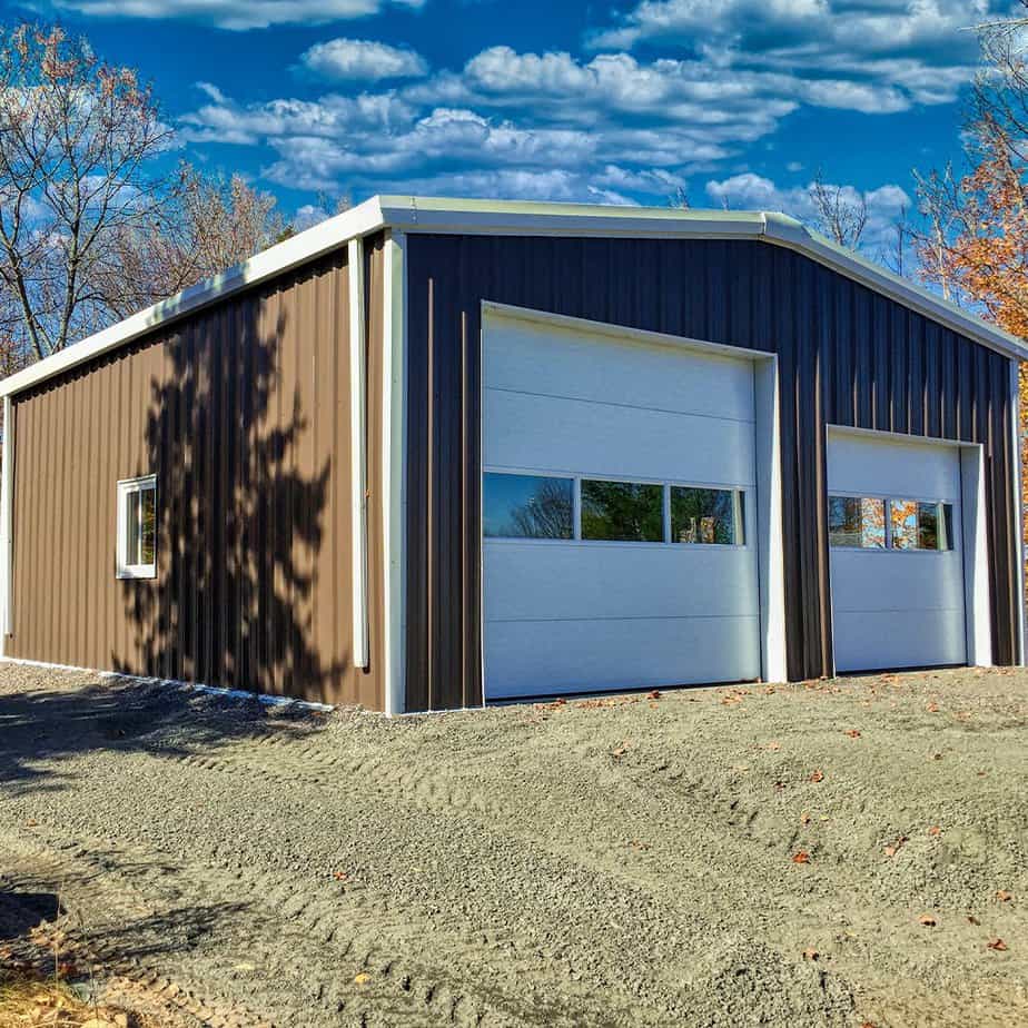 Prefab garage steel building with one large door and one regular door.