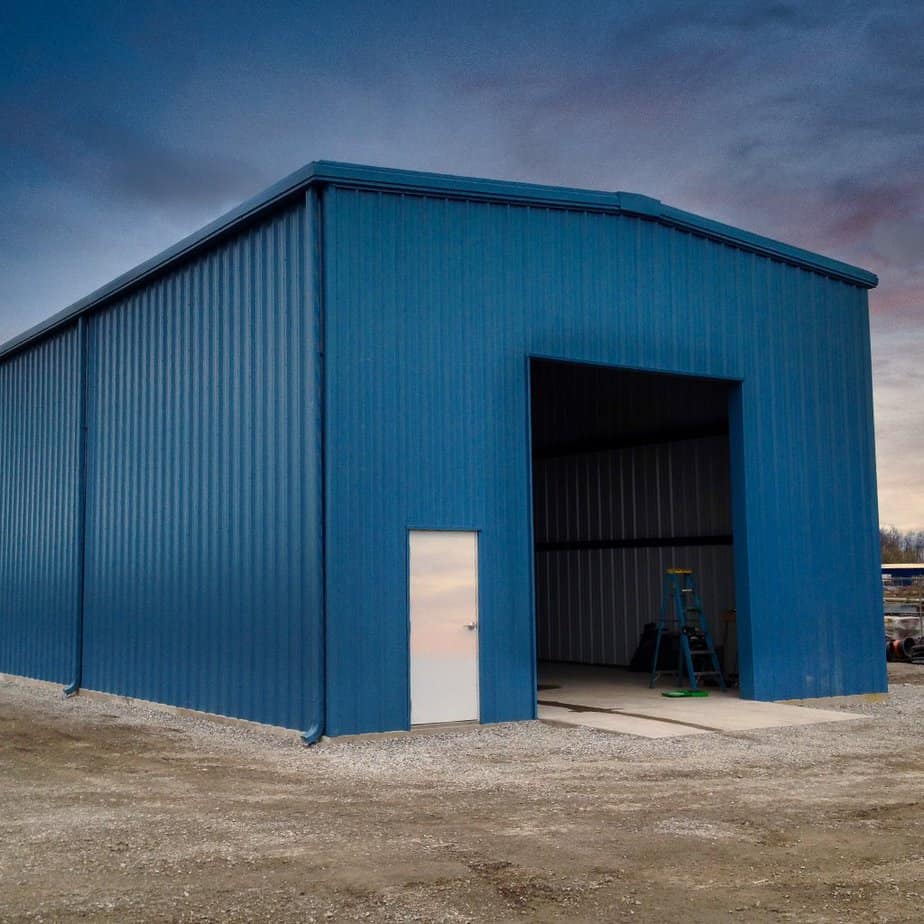 Prefab garage steel building with one large door.