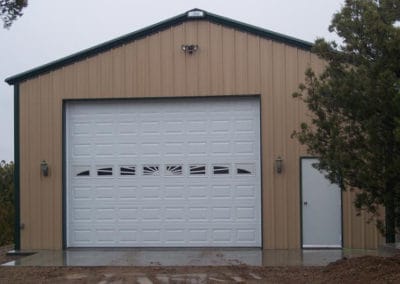 Prefab garage steel building with one door.