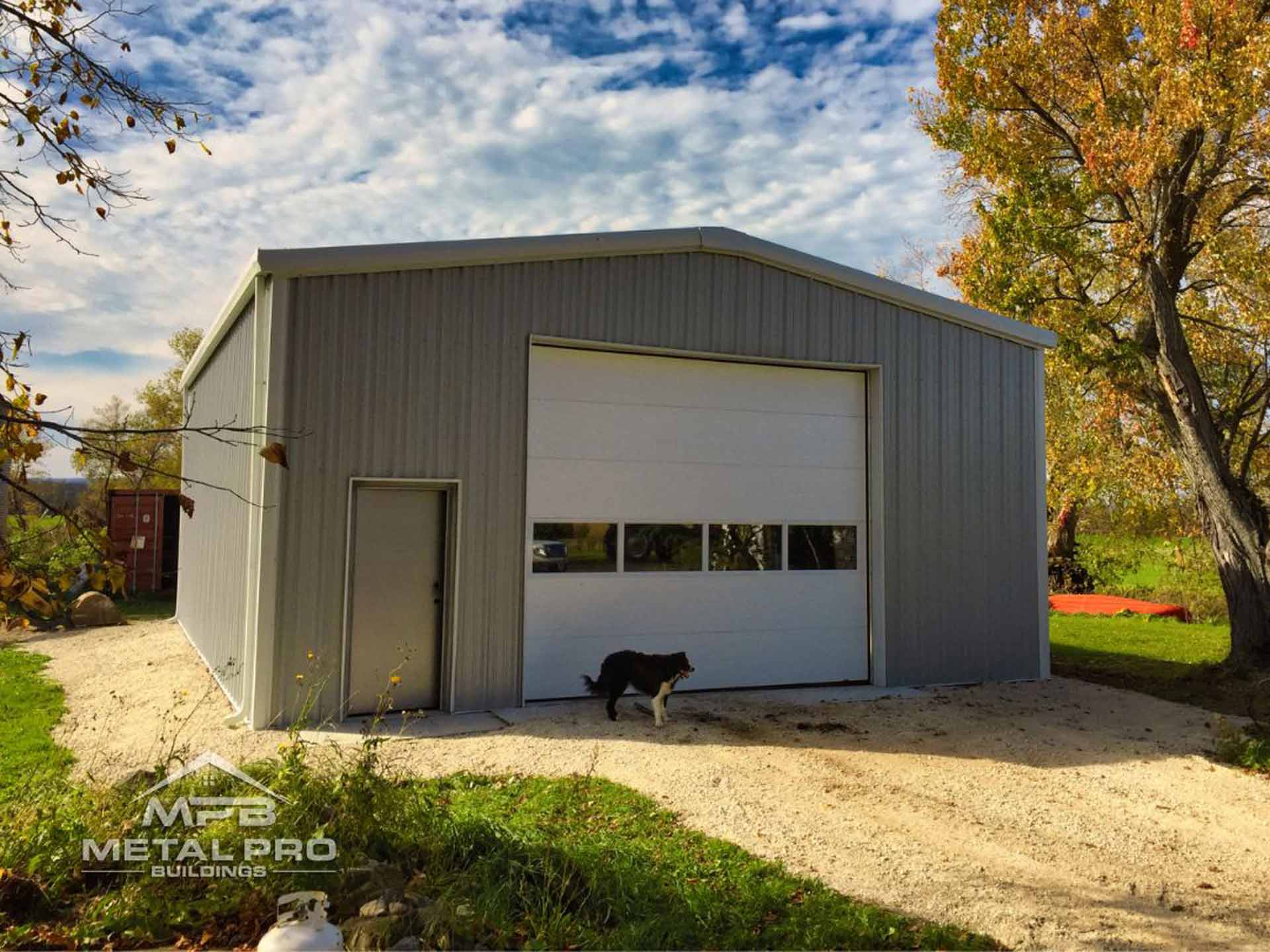 exterior of a prefabricated garage with a service door