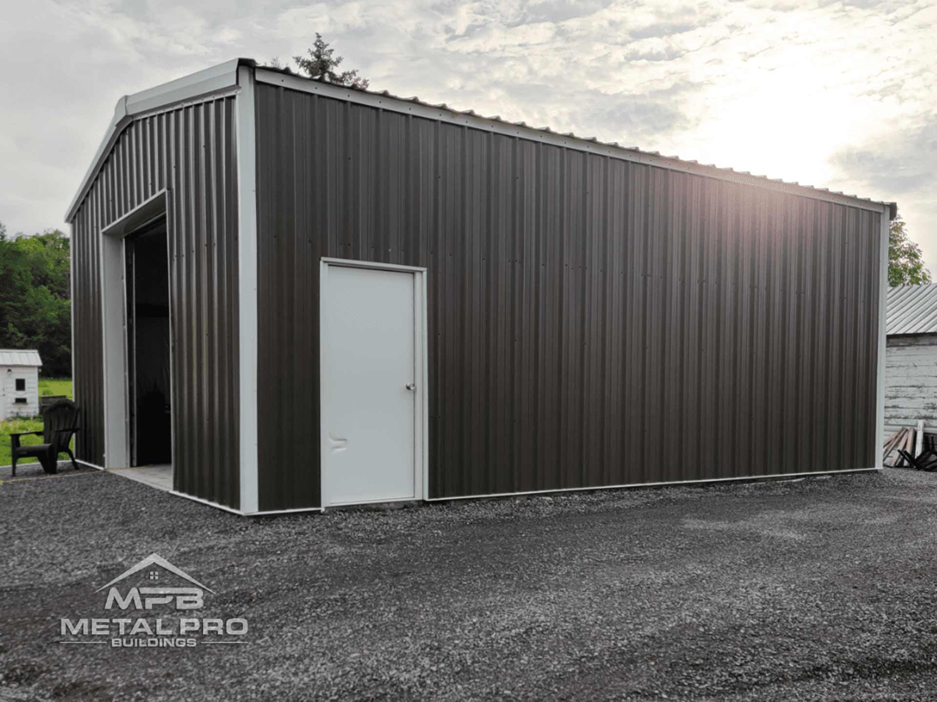 exterior of a prefabricated steel garage building with a service door