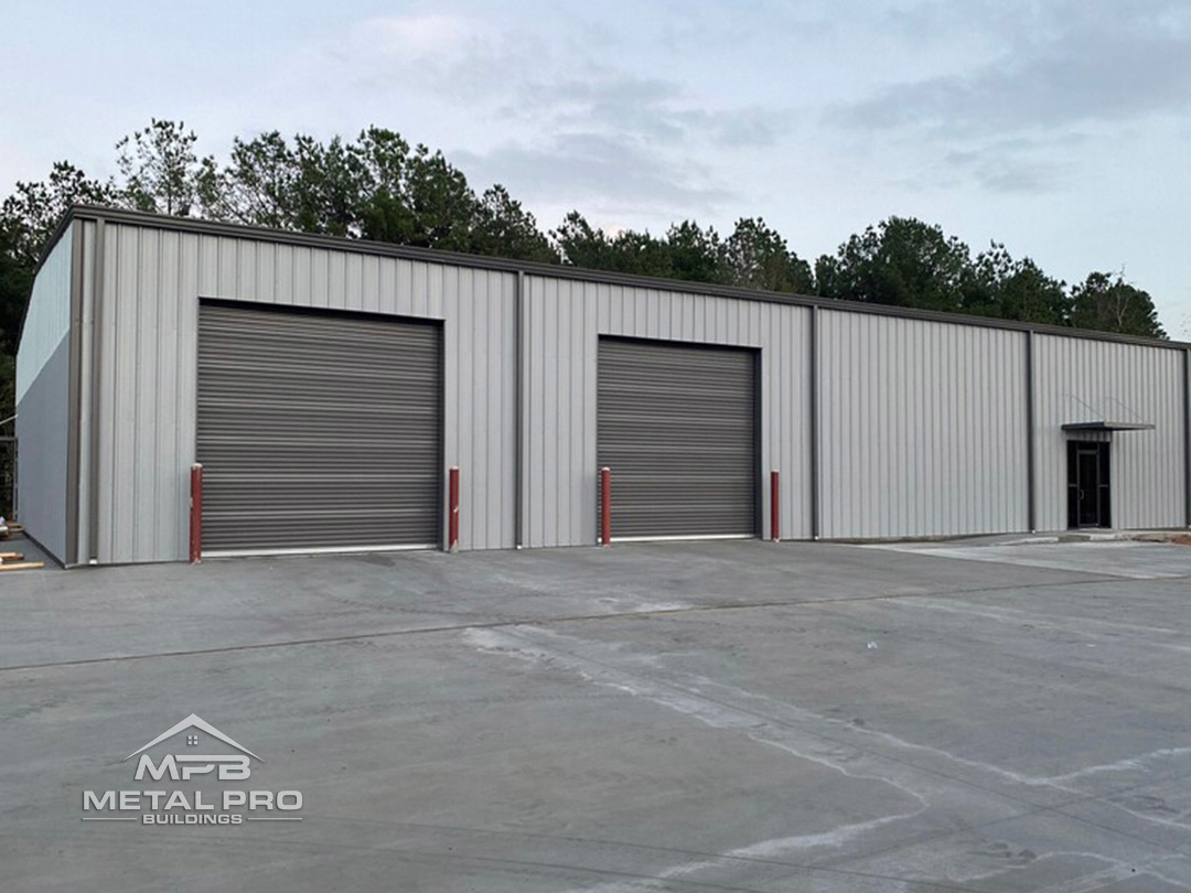 I-Beam industrial building with grey painted roof, walls, and garage doors.