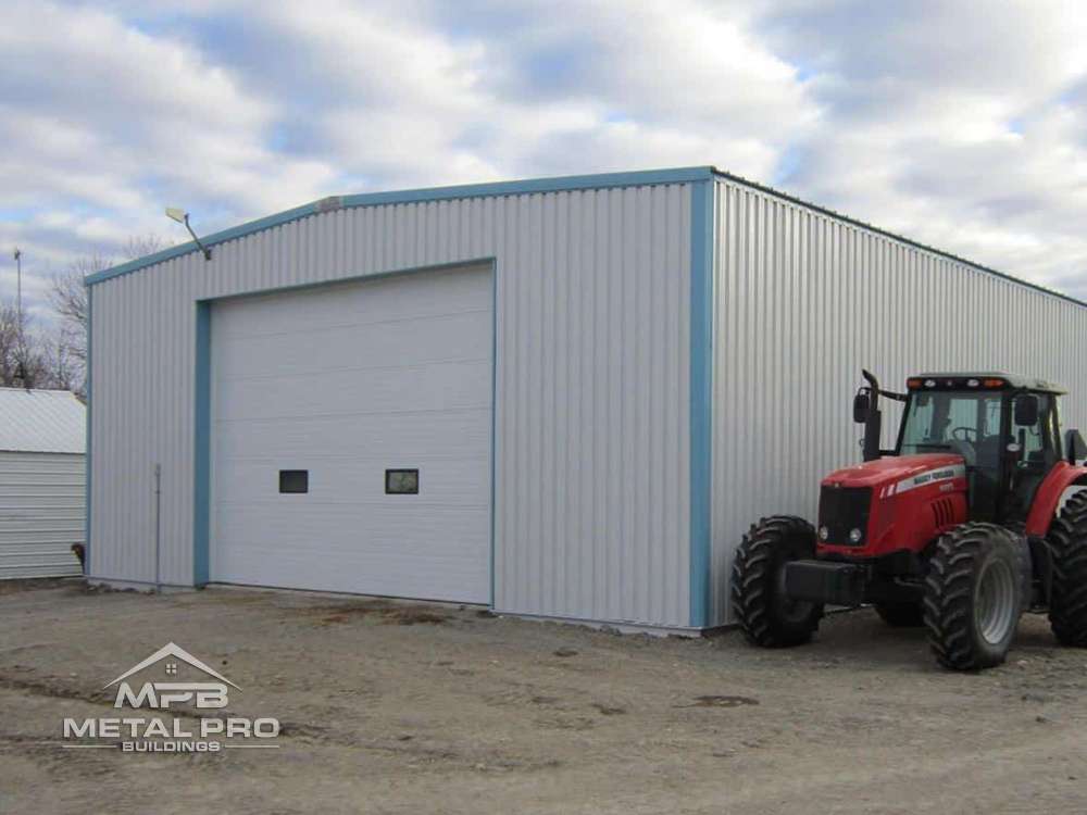 exterior of an agricultural steel building with a tractor on the side