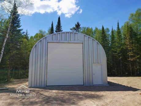 quonset hut building, steel endwall finish , with white garage and entry door