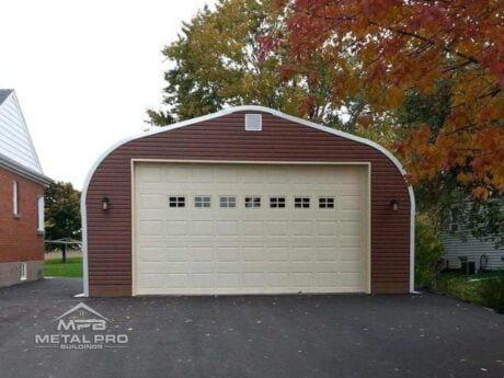 quonset hut building, vinyl finish, with cream garage door