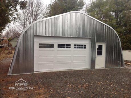 quonset hut building, aluminum finish, with white garage and entry door