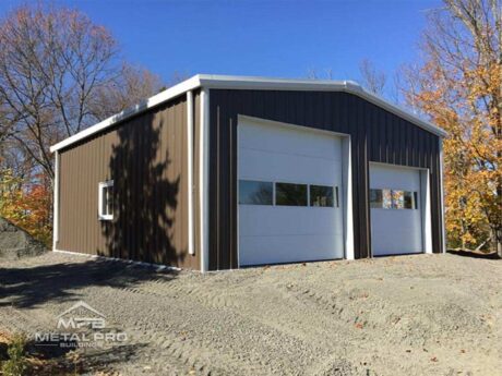 brown straight wall garage building with one large and one medium garage door