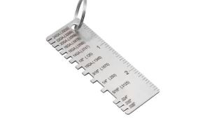 Metal thickness gauge keychain with labeled notches and inch ruler