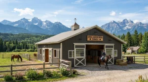 Steel horse barn with riding area, horses, and mountain scenery on a Canadian farm.