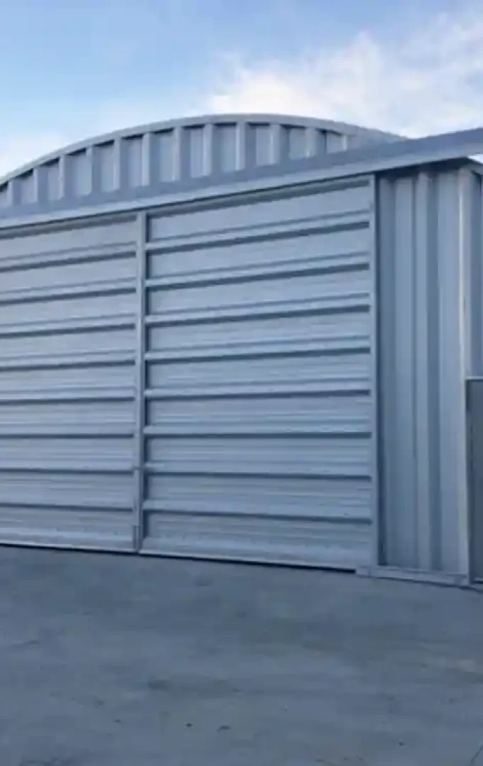 quonset hut arch steel storage building with garage and entry door