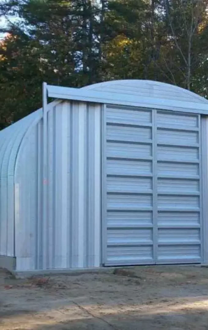 quonset hut workshop building with sliding garage doors